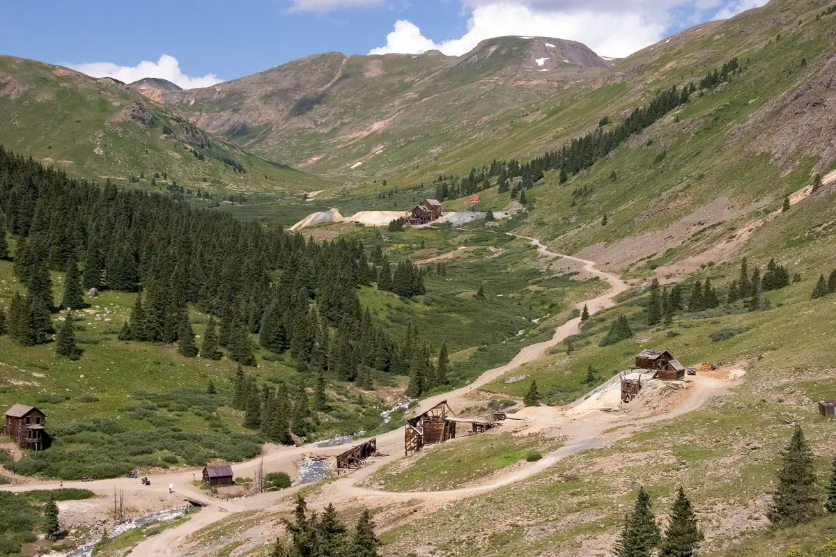 Looking down on the Animas Forks townsite in July 2006, with its scattered wooden buildings and dirt roads below Tuttle Mountain.
